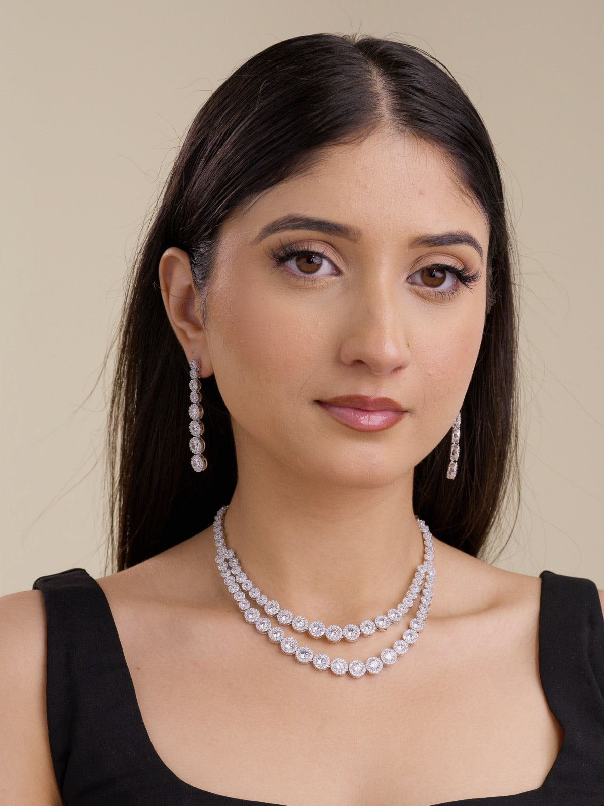 American Diamond double strand necklace set in silver tone with matching long earrings, shown on model with a black outfit.