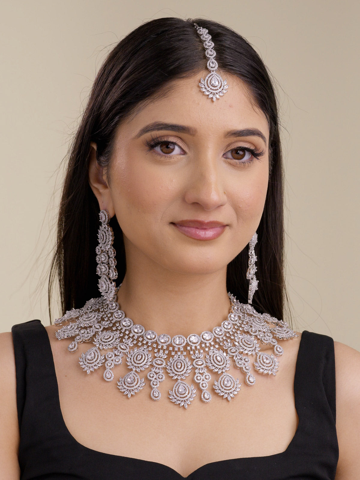 American Diamond necklace set in silver tone with neutral clear stones, shown on a model with matching long earrings and maang tikka in a full front bridal-style view.