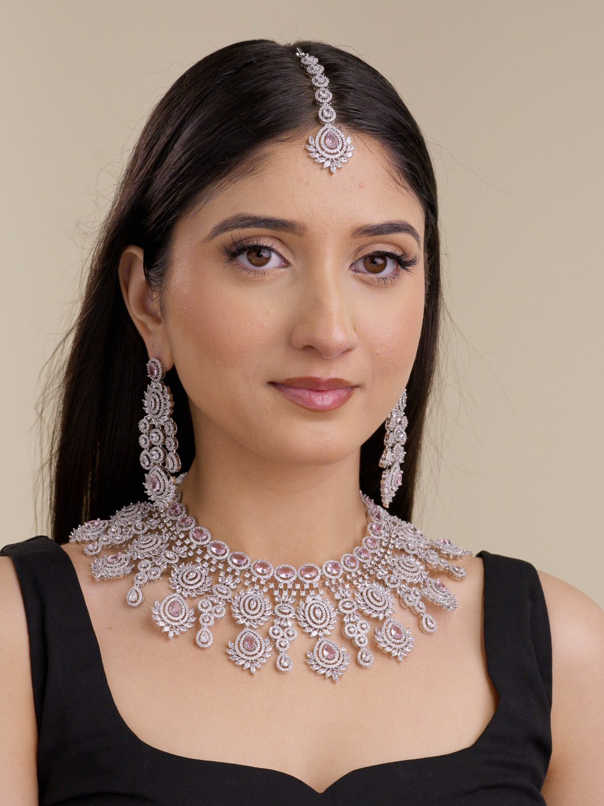 American Diamond necklace set in silver tone with soft blush-pink stones, shown on a model with matching long earrings and maang tikka in a full front bridal-style view.