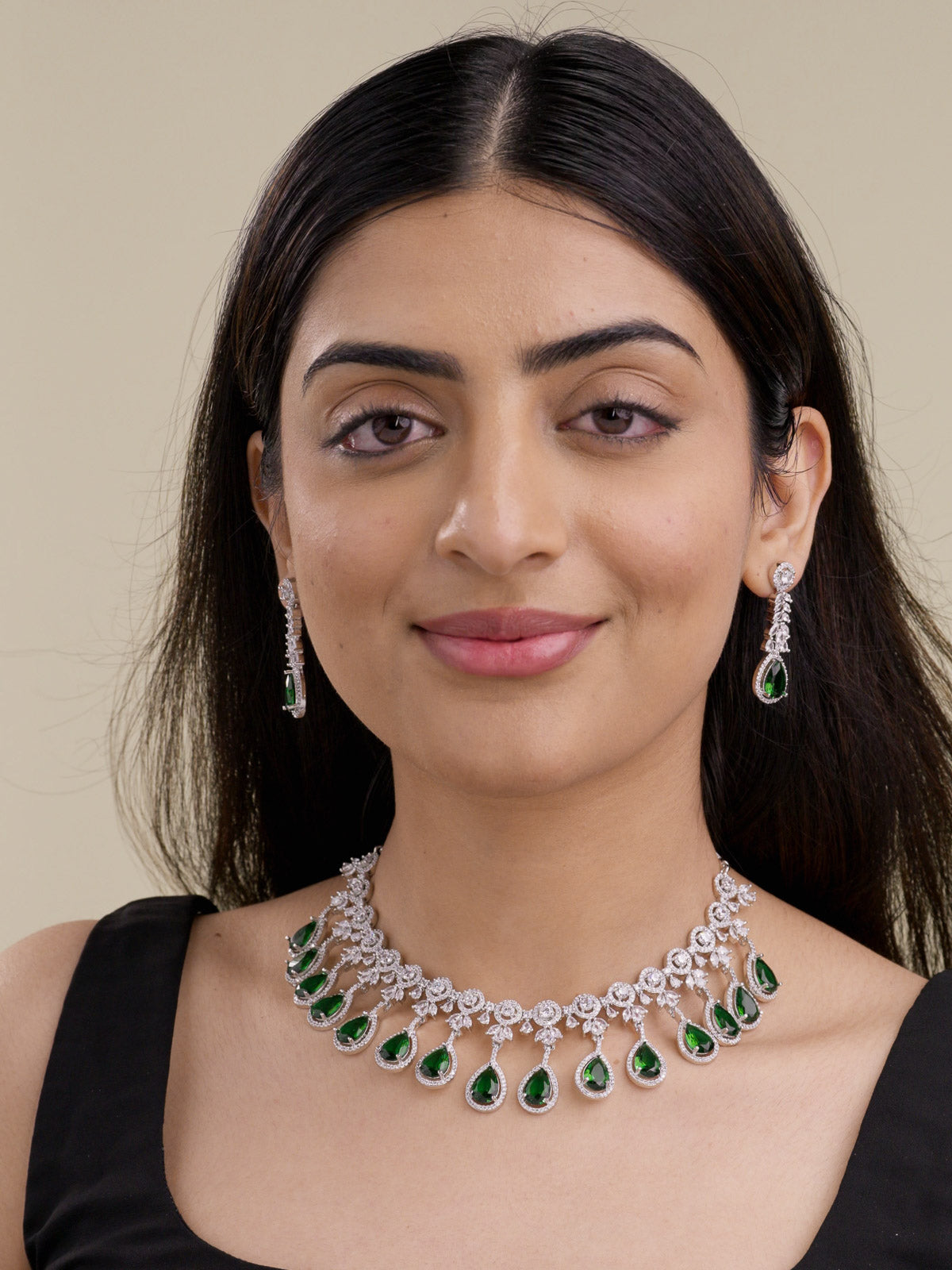 American Diamond necklace set in silver tone with green teardrop fringe, CZ detailing, and matching drop earrings on model front-view image