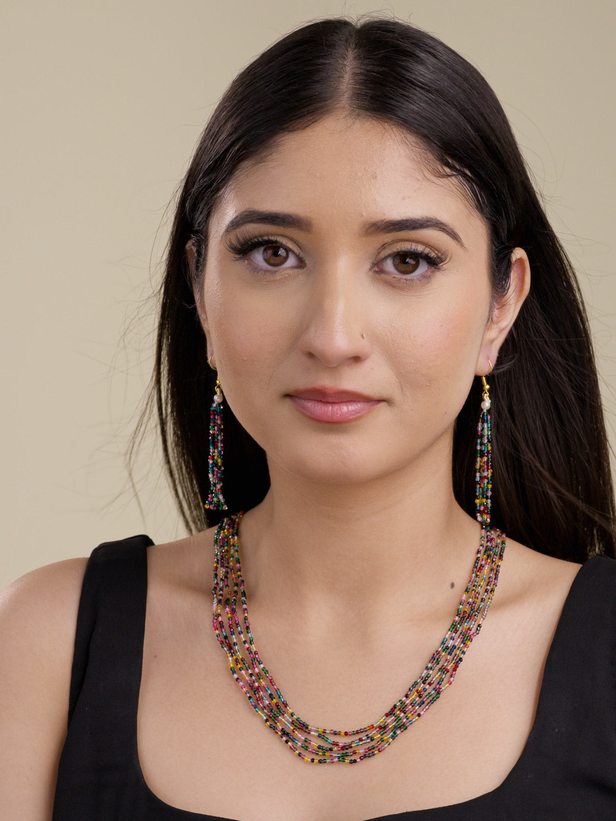 Model shot of multi colour multi-strand beadwork necklace set with matching faceted bead tassel hook-style earrings.