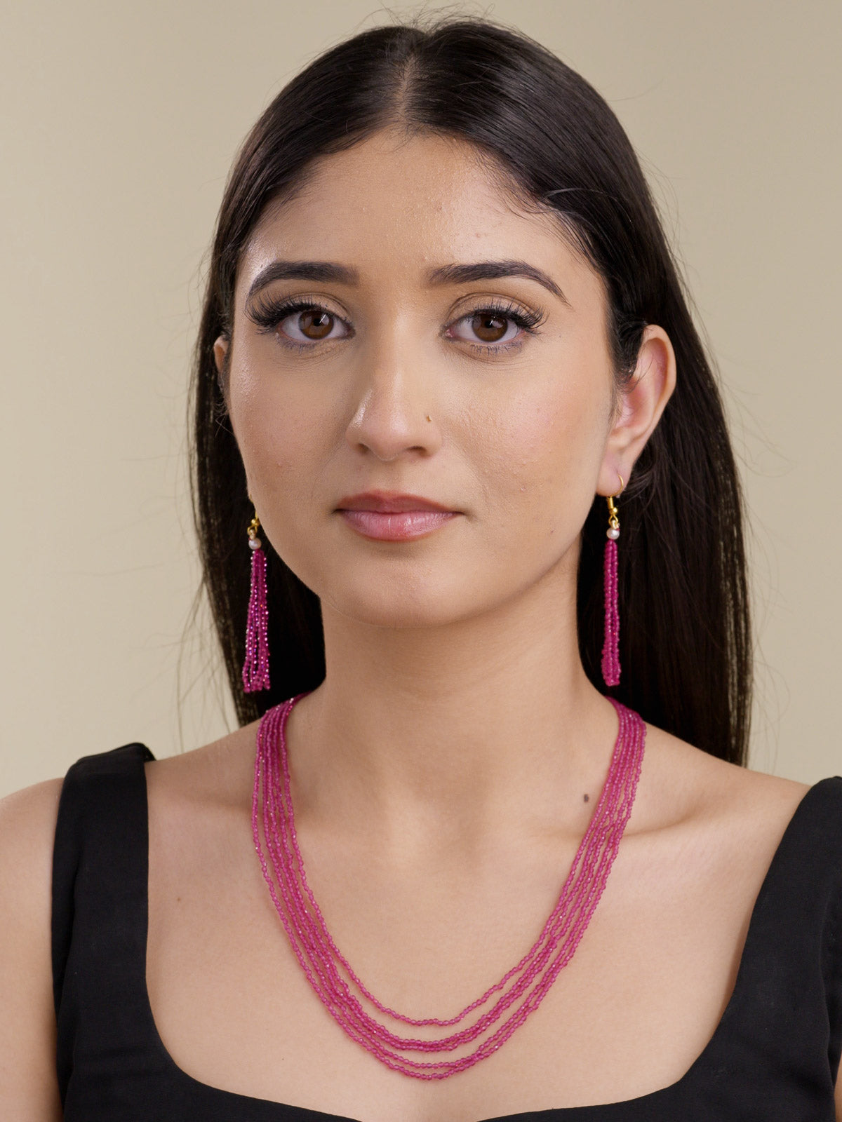 Model shot of ruby pink multi-strand beadwork necklace set with matching faceted bead tassel hook earrings.