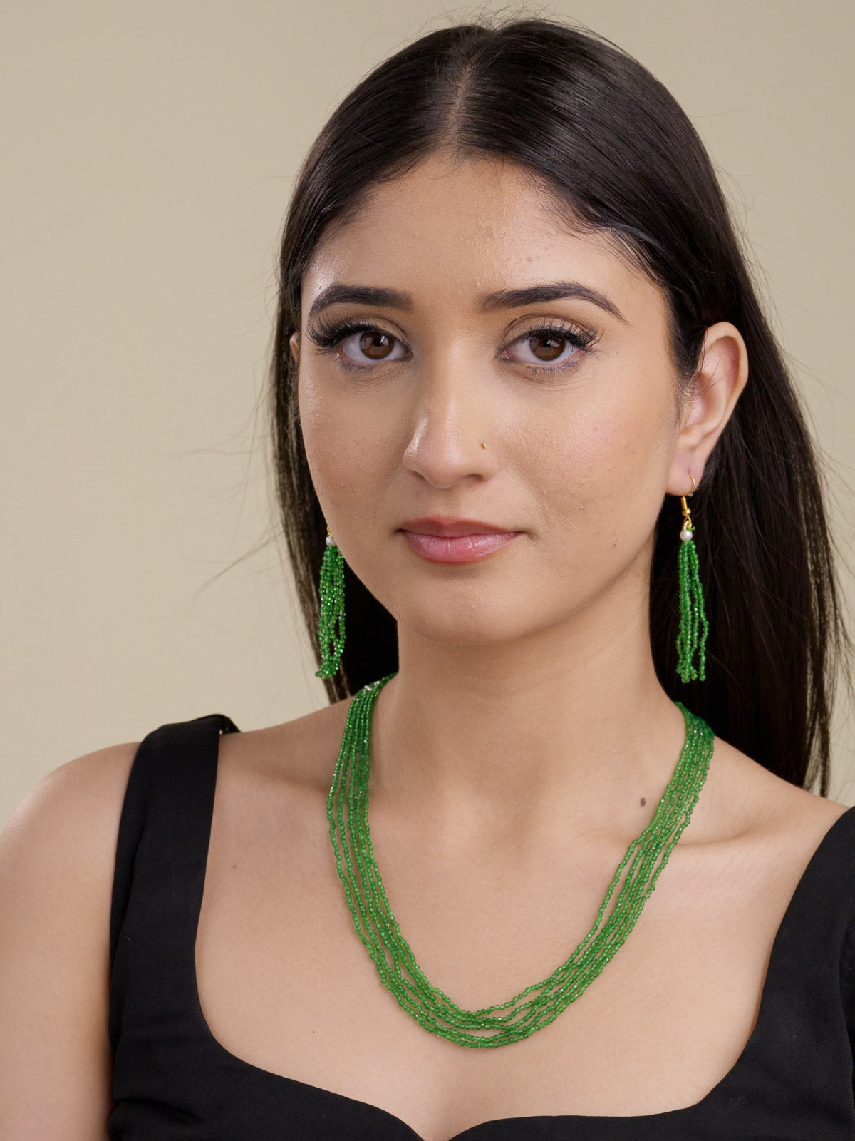 Model shot of sage green multi-strand beadwork necklace set with matching faceted bead tassel hook earrings.